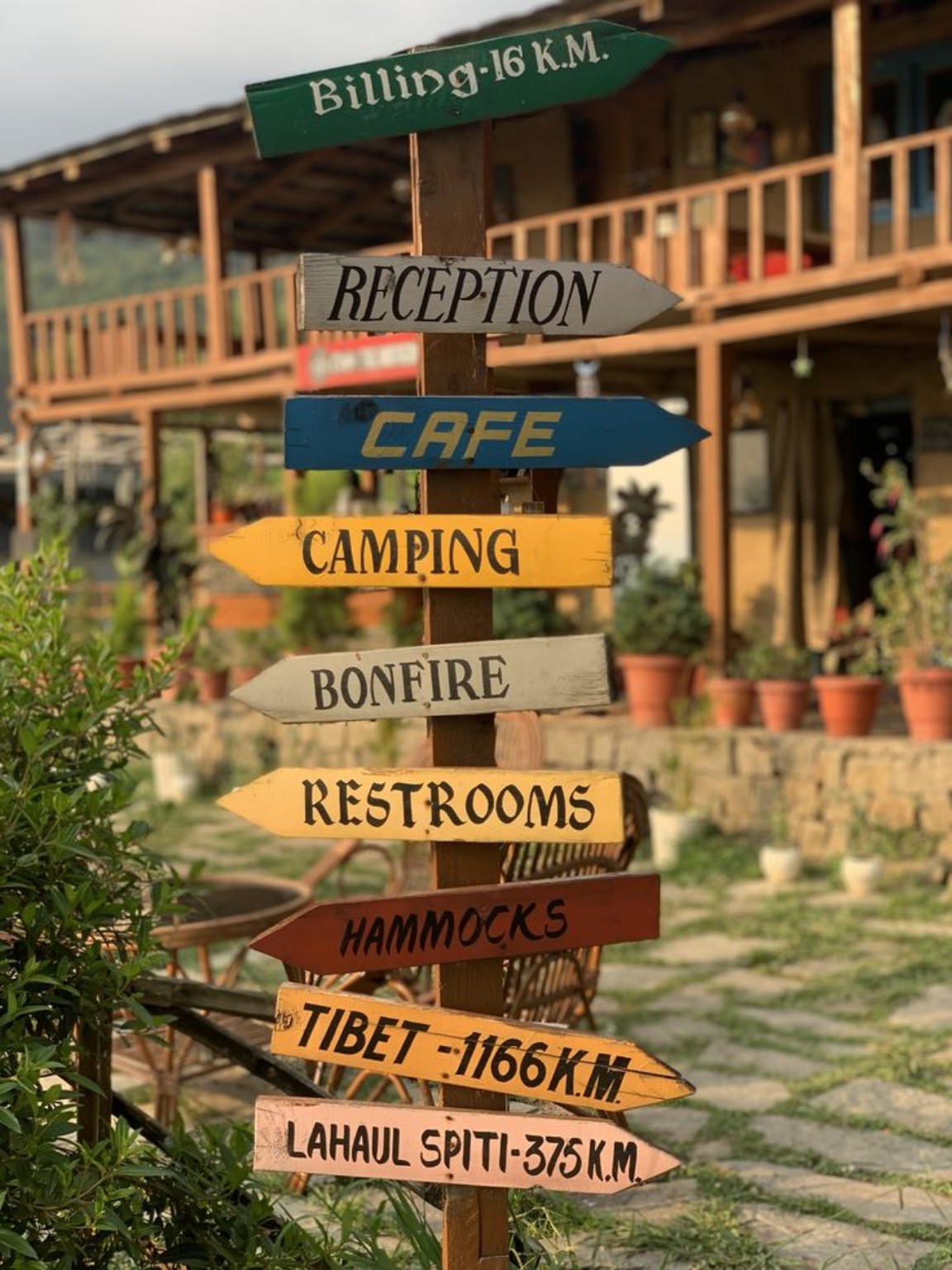 Wooden camping and bonfire signposts outside a mountain stay